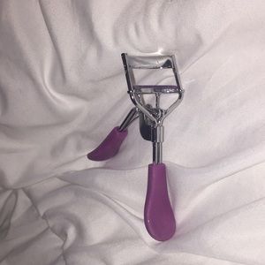 This is a purple handle and silver eyelash curler